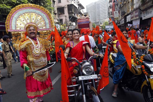 People dressed in traditional attires take out a procession to celebrate