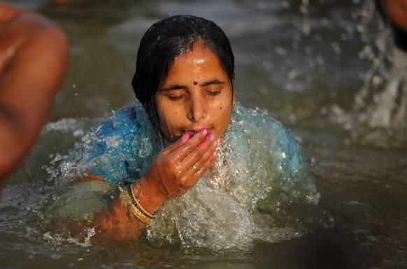 A Hindu devotee takes a holy dip in the river Ganges on the first day of the nine-day Hindu festival of