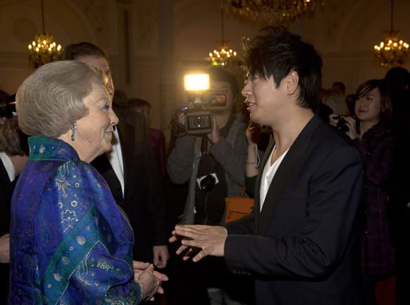 Dutch Queen Beatrix, left, talks to pianist Lang Lang of China after attending a concert marking the 125th anniversary of the Royal Concert Hall Orchestra in Amsterdam, Netherlands.
