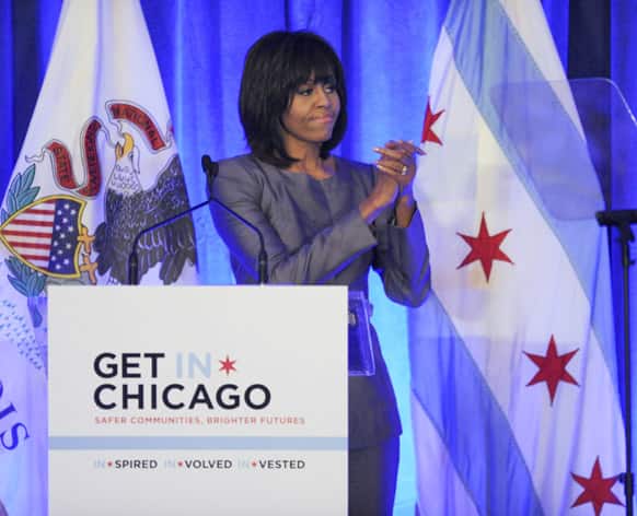 First lady Michelle Obama says goodbye to the crowd after speaking during a luncheon at the Chicago Hilton in Chicago.