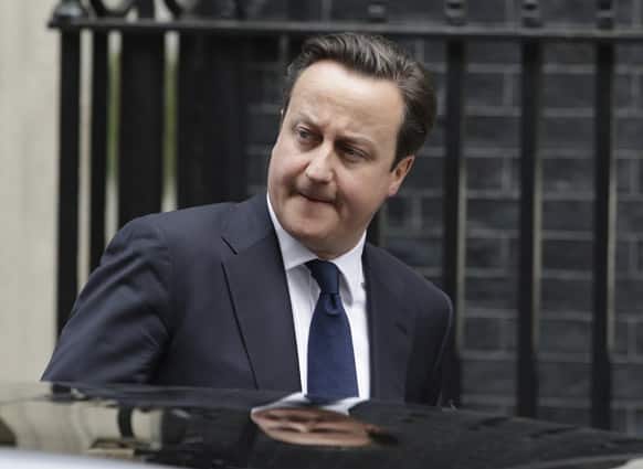 British Prime Minister David Cameron leaves his official residence at 10 Downing street in London, on his way to the Houses of Parliament. The British Parliament was convened for a special session Wednesday to pay tribute to former prime minister Margaret Thatcher.