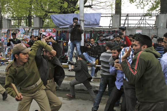 Policemen beat Kashmiri government employees during a protest in Srinagar. Police used force to stop the government employees during a protest called by the workers` union demanding regularization of contractual jobs and a hike in salary.