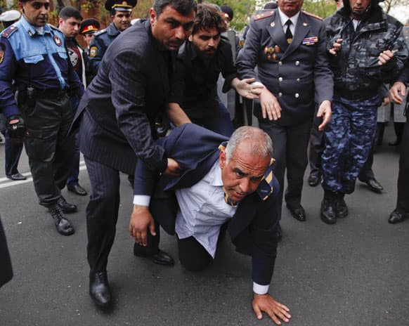 Armenian election runner-up Raffi Hovanessian is helped up after he fell during clashes between his supporters and police in Yerevan, Armenia.