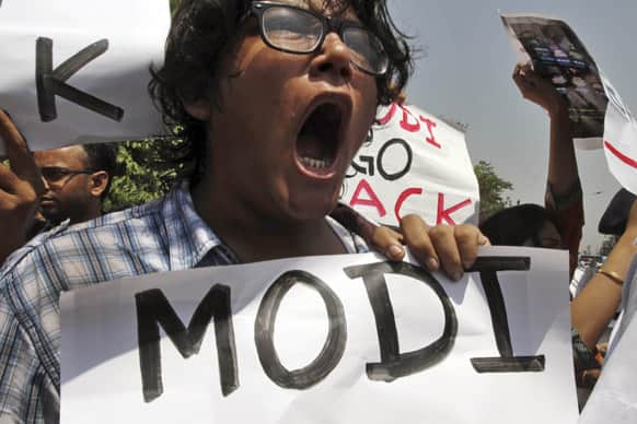 Activists of Naxalite group shout slogans as they protest the visit of Gujarat state Chief Minister Narendra Modi outside a hotel in Kolkata.