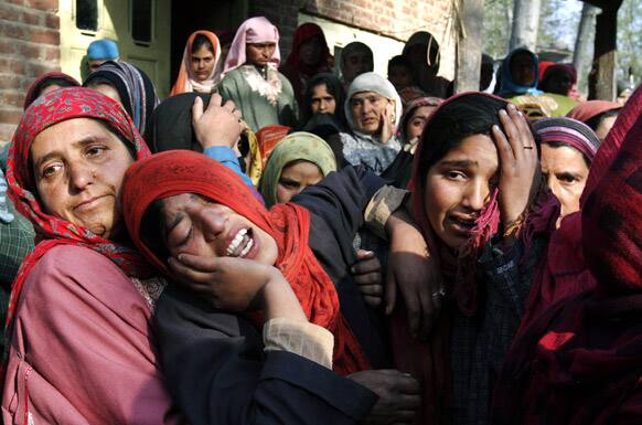 Relatives and neighbors cry during the funeral procession of village headman Gulam Muhammad Lone in Kolpora Nyayna village, Srinagar.