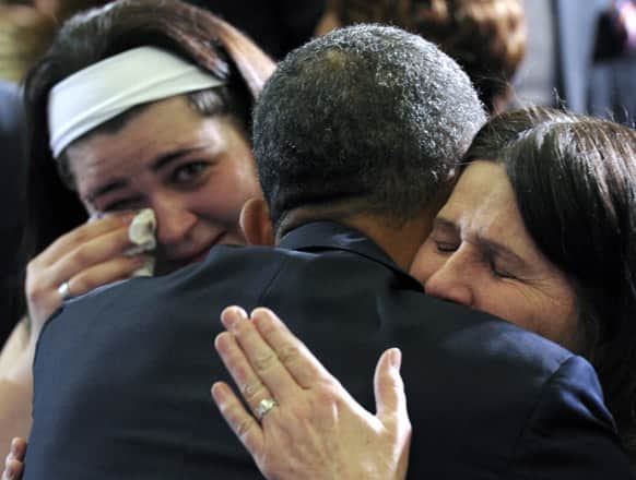 President Barack Obama hugs Newtown, Conn., family members after speaking at the University of Hartford in Hartford, Conn. Obama said that lawmakers have an obligation to the children killed and other victims of gun violence to act on his proposals.