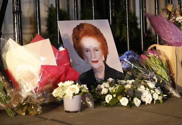 Flowers placed by well-wishers surround a portrait of former British Prime Minister Margaret Thatcher outside her home in Belgravia, London.