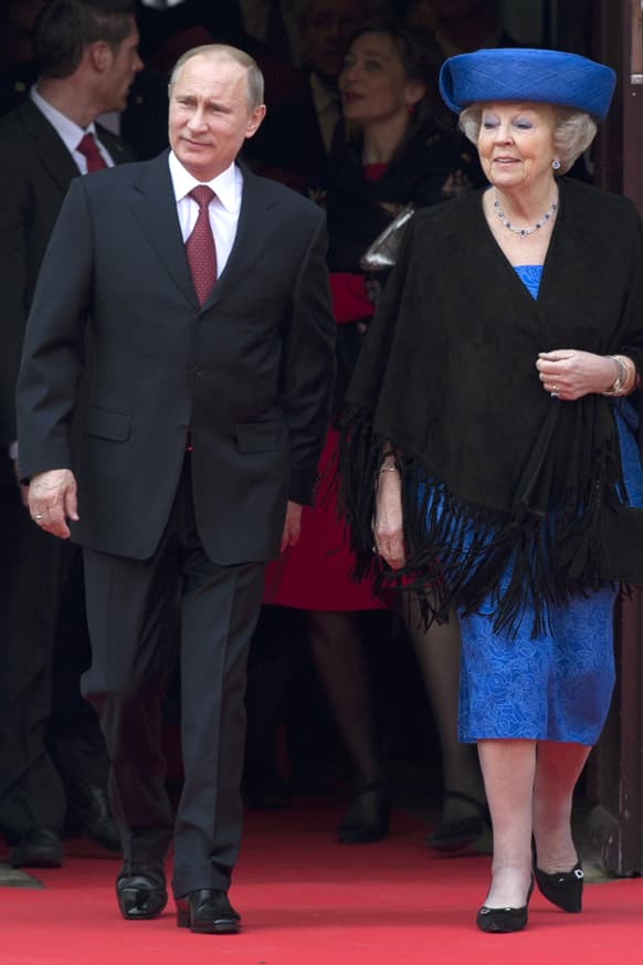 Russian President Vladimir Putin, left, and Dutch Queen Beatrix, right, arrive at the Amsterdam Hermitage museum, marking the official start of the Netherlands-Russia year 2013.
