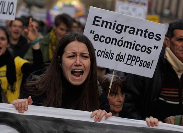 Demonstrators shouts slogans as they carry a banner reading,