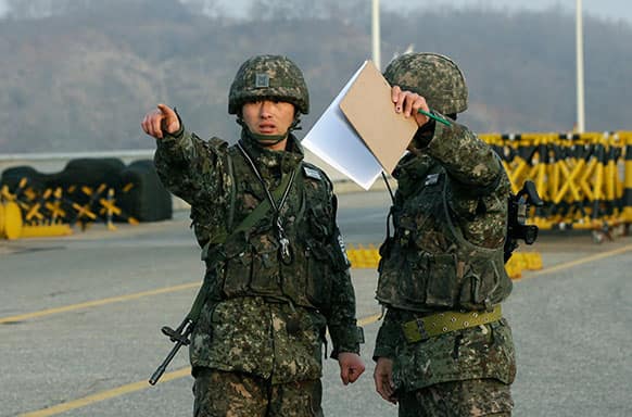 South Korean army soldiers talk near a barricade set up on Unification Bridge near the border village of Panmunjom, which has separated the two Koreas since the Korean War, in Paju, north of Seoul, South Korea.