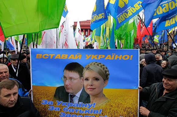 Supporters of the Ukrainian Opposition party holds a poster with a picture of former Ukrainian Prime Minister Yulia Tymoshenko,right, and former Ukrainian Interior Affairs Minister Yuri Lutsenko,left, during a rally in Kiev, Ukraine.