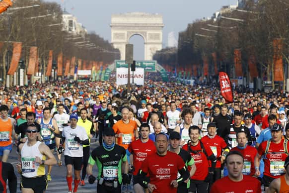The runners taking part in the 37th Paris Marathon start the race on the Champs Elysees in Paris.
