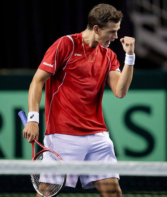 Canada`s Vasek Pospisil celebrates a point while playing with Daniel Nestor against Italy`s Daniele Bracciali and Fabio Fognini during the third set of a Davis Cup tennis doubles match in Vancouver, British Columbia.