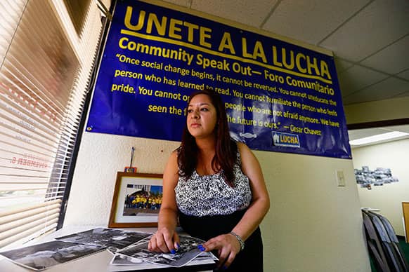 Reyna Avila, who recently received a work permit and Social Security card under new Obama administration policy for young immigrants, is shown here at her place of work in Phoenix.