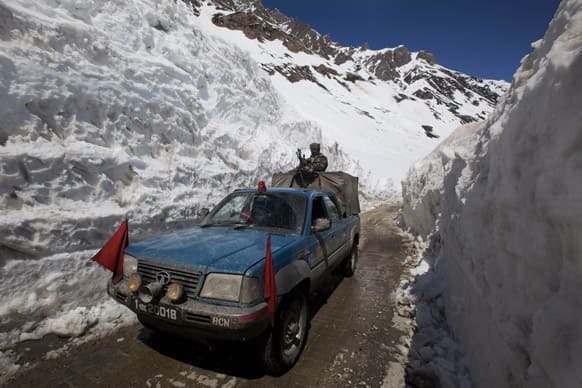An Indian army vehicle passes walls of snow near Zojila Pass, about 110 kilometers (68 miles) north of Srinagar. The Srinagar-Leh National Highway connecting Ladakh to the Kashmir Valley was re-opened to traffic Saturday after remaining closed for nearly six months.