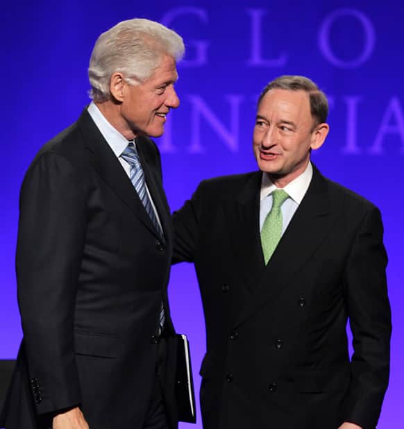 Former President Bill Clinton greets Mark S. Wrighton, chancellor of Washington University, during the opening session of the Clinton Global Initiative at Washington University in St. Louis.