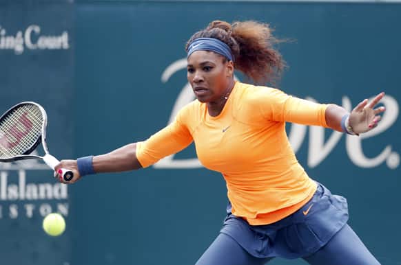 Serena Williams returns to Mallory Burdette at the Family Circle Cup tennis tournament in Charleston, S.C.
