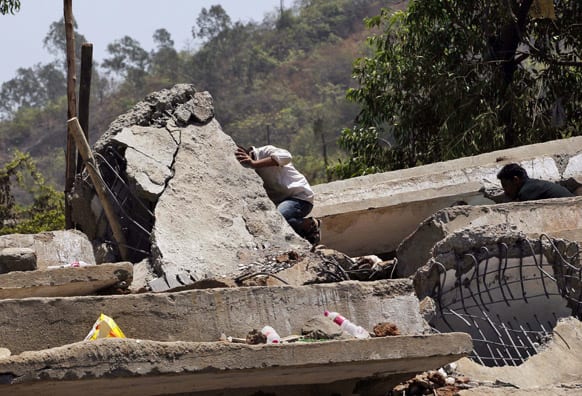Men search for survivors in the debris of a building that collapsed on the outskirts of Mumbai.
