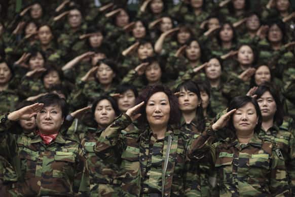 South Korean army reservists salute during their Foundation Day ceremony at a gymnasium in Seoul, South Korea. About 1,000 reservists gathered here to denounce North Korean for their escalating threat for war.