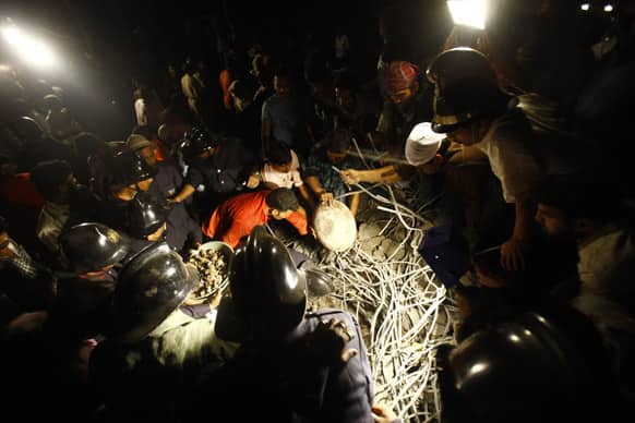 Rescue workers look for trapped people after a residential building collapsed in Thane, Mumbai.
