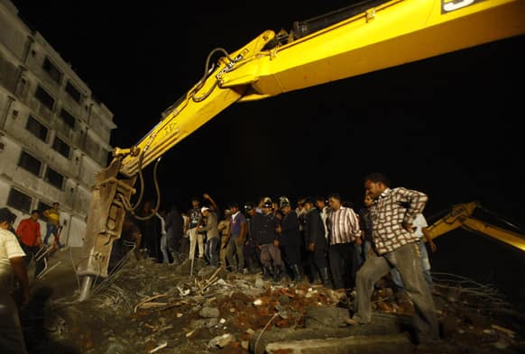 Rescue workers look for trapped people after a residential building collapsed in Thane, Mumbai.