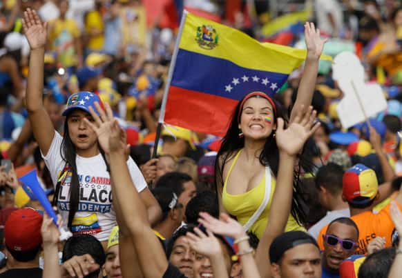 Supporters of opposition presidential candidate Henrique Capriles wave at him during a campaign rally in Maracay, Venezuela. Venezuela will hold a presidential election to replace late President Hugo Chavez on April 14.
