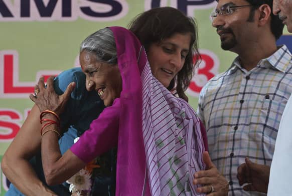 American Astronaut of Indian origin, Sunita Williams, hugs a woman during her visit to her ancestral village Jhulasan in Mehsana district of Gujarat.