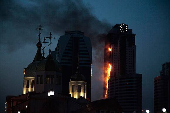 A fire rages in an unoccupied 40-story apartment building under construction in provincial capital Grozny in Chechnya,, Russia.