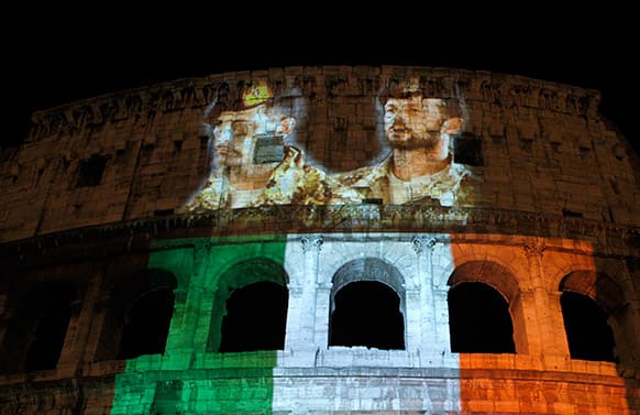 Pictures of the Italian marines Massimiliano Latorre and Salvatore Girone, detained in India to face trial in the deaths of two fishermen, and the colors of the Italian flag are projected atop the Colosseum during a demonstration organized by the Rome munucipality to ask for their release, in Rome.