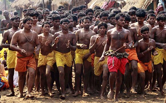 Devotees dance before performing rituals of penance on hot sand on the second day of the Danda festival or the festival of self-punishment, at Kulagarh in Ganjam district, Orissa state, India.
