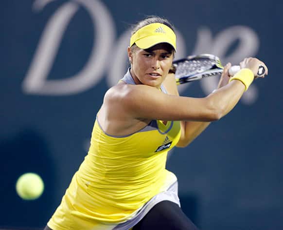 Monica Puig, of Puerto Rico, returns to Venus Williams at the Family Circle Cup tennis tournament in Charleston, S.C.