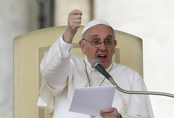 Pope Francis gestures as he speaks during his weekly general audience in St. Peter square at the Vatican.