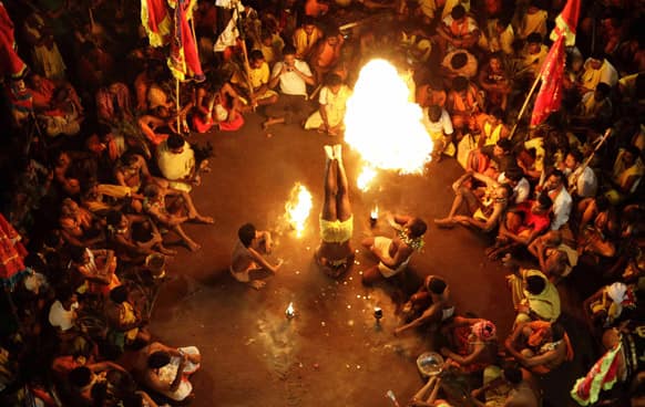 A devotee performs penance with fire on the beginning day of the Danda festival at Sorada village, Bhubaneswar. Devotees inflict physical pain as they perform rituals of penance to appease Shiva.
