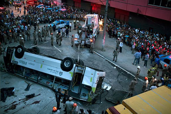 A bus is seen upside down after falling from a viaduct into Avenida Brasil, the largest avenue in Rio de Janeiro, Brazil.