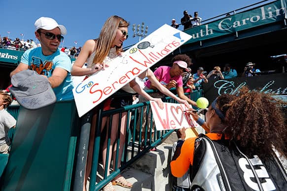 Serena Williams signs autographs after her match against Camila Giorgi, of Italy, at the Family Circle Cup tennis tournament in Charleston, S.C.
