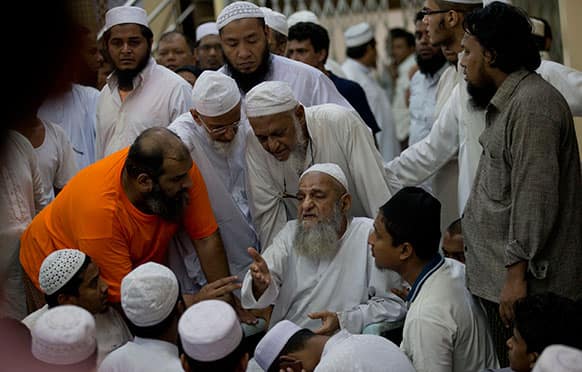 Muslim religious leaders gather at a mosque following a fire that killed 13 children at a mosque in Yangon, Myanmar. Police in Myanmar said 13 children died when an electrical fire broke out at the mosque in the country`s largest city.