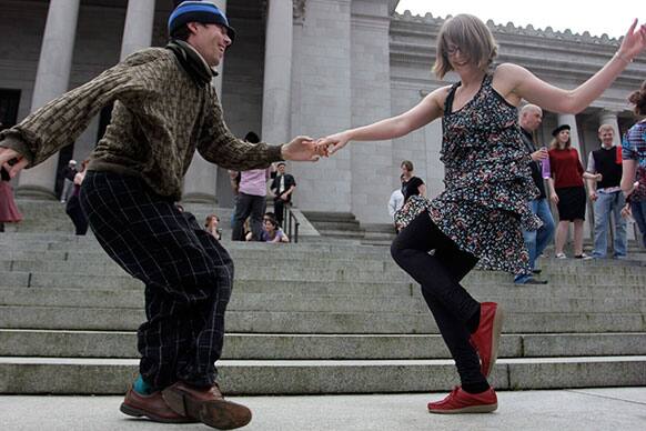 Melissa Petersen and Kevin Buster dance on the steps of the Capitol in Olympia, Wash., to protest a decades-old state tax on dance venues. Washington state has had the tax, which targets venues that provide an opportunity to dance, since the 1960s.