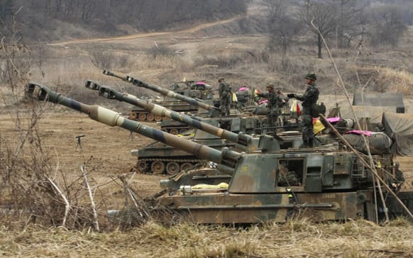 South Korean marines stand on their K-55 self-propelled howitzers during an exercise against possible attacks by North Korea near the border village of Panmunjom in Paju, South Korea.