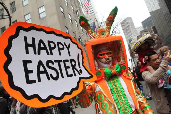 Davey Mitchell, of New York, left, poses for photographs on New York`s Fifth Avenue as he takes part in the Easter Parade.