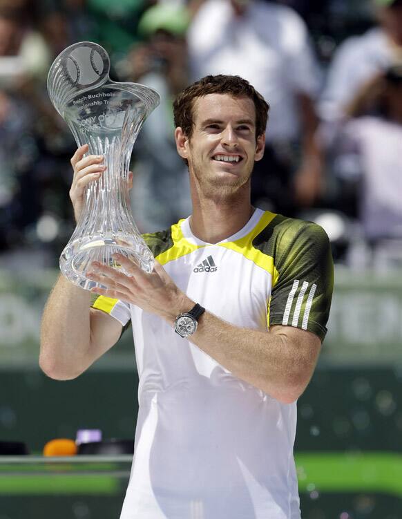 Andy Murray of Britain holds up his trophy after defeating David Ferrer of Spain, 2-6, 6-4, 7-6 (1) in the final match of the Sony Open tennis tournament.