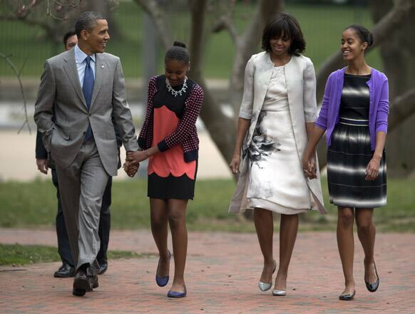 President Barack Obama and first lady Michelle Obama walk from the White House with their daughters Sasha Obama, second from left, and Malia Obama, right, on their way through Lafayette Park to St. John`s Episcopal Church for Easter services.