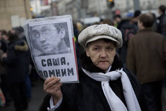 A protester holds a portrait of Alexander Dolmatov who had sought political asylum in the Netherlands and committed suicide, in a Rotterdam detention centre while awaiting deportation to his homeland, during a banned anti-Kremlin protest in Moscow, Russia.