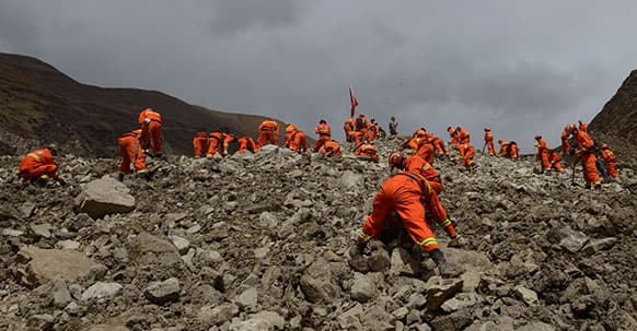 Rescue workers conduct search and rescue work at the site where a large-scale landslide hit a mining area in Maizhokunggar County of Lhasa, southwest China`s Tibet Autonomous Region.
