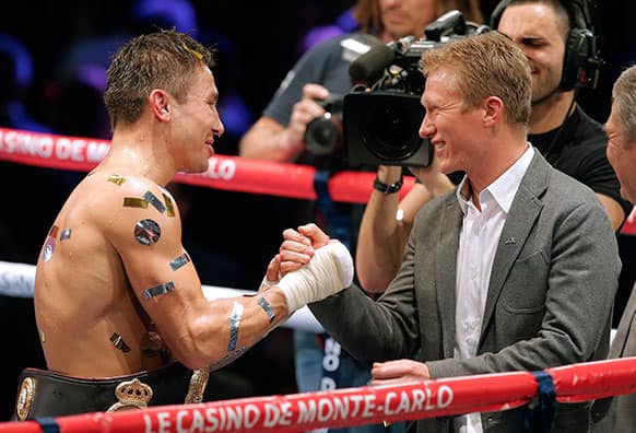 Former Kazakhstani professional road bicycle racer and current general manager of UCI, Alexander Vinokourov, right, congratulates compatriot Gennady Golovkin after his victory against Nobuhiro Ishida of Japan for the WBA middleweight world title, in Monaco.