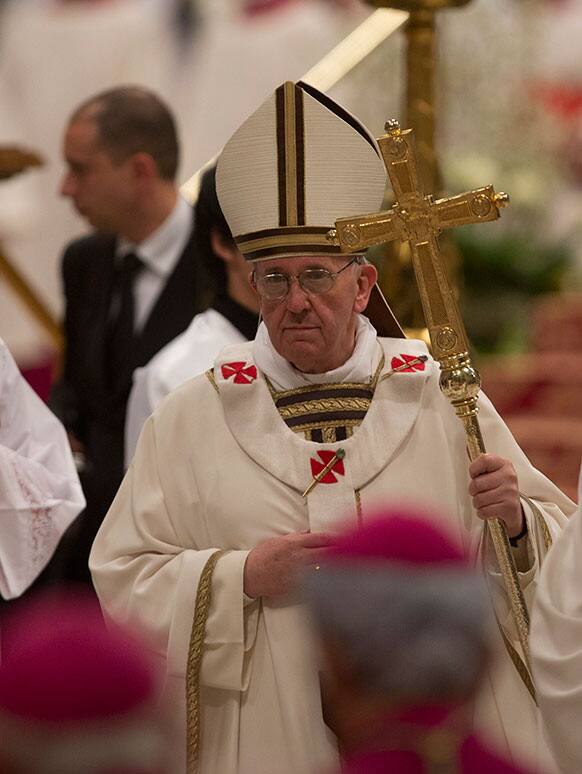 Pope Francis leaves after celebrating the Easter vigil service in St. Peter`s Basilica, at the Vatican.