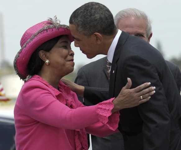 President Barack Obama is greeted by Rep. Frederica Wilson, D-Fla., after walking down the steps of Air Force One at Miami International Airport in Miami.