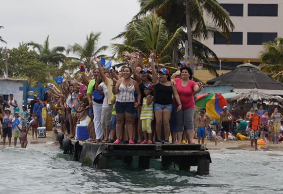 Supporters of opposition presidential candidate Henrique Capriles cheer during a campaign visit by Capriles at Morrocoy Keys, a vacation resort near Chichiriviche, Venezuela.
