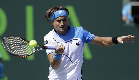 David Ferrer, of Spain, returns to Tommy Haas, of Germany, during a semifinal match at the Sony Open tennis tournament, in Key Biscayne, Fla.