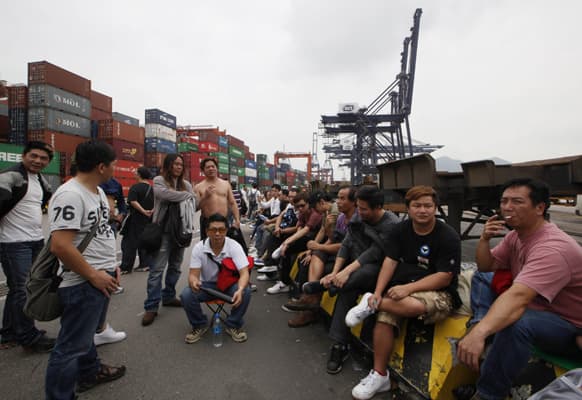 Container workers occupy and block a road during a protest at Kwai Chung Container Terminal in Hong Kong.