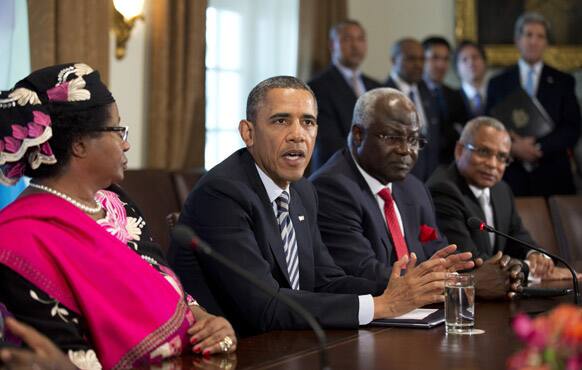 President Barack Obama speaks in the Cabinet Room of the White House in Washington, after a meeting with Malawi President Joyce Banda, Sierra Leone President Ernest Bai Koroma and Cape Verde Prime Minister José Maria Pereira Neves. Standing back right is Secretary of State John Kerry.